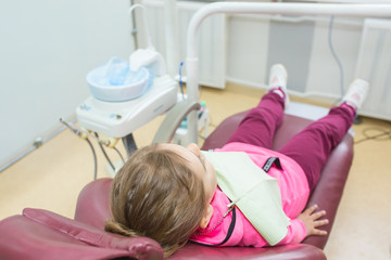 Little girl in dentist clinic. Health care, medicine concept