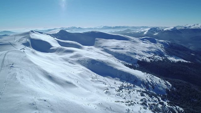 Bewitching view of the majestic snowdrifts located in the mountains on a sunny cloudless winter day. The concept of beautiful northern nature and wonders of the world.