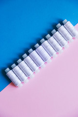 Row Of WhiteThread Spools On Table flatlay