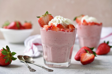 Strawberry mousse with whipped cream and fresh berries in a glasses.