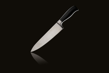 Sharp large kitchen knife with handle on black isolated background