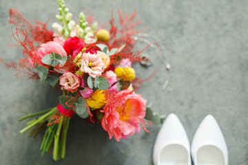 Wedding details. envelope, invitation, wedding rings and a bouquet of flowers, shoes of the bride.