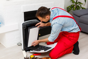 air purifier repairman turning a filter into a new one.