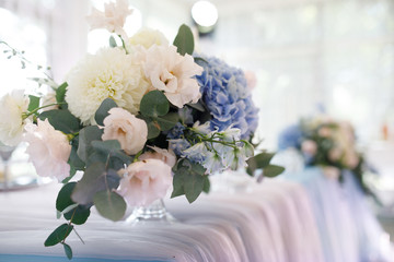 banquet table is decorated with plates, cutlery, glasses, candles and flower arrangements