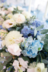 banquet table is decorated with plates, cutlery, glasses, candles and flower arrangements