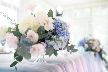 banquet table is decorated with plates, cutlery, glasses, candles and flower arrangements