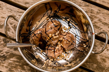 Chocolate ice cream in a silver bowl