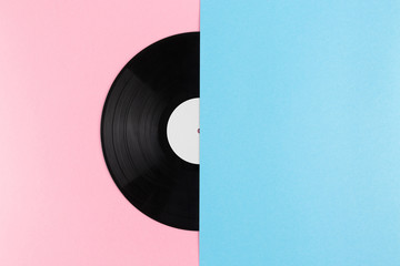 Half of vinyl record on abstract creative pastel pink and blue pastel background with copy space
