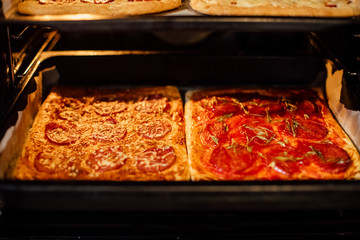 pizza is on a platter in the oven