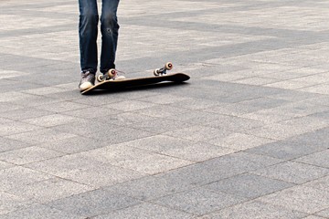 teenager and overturned skateboard