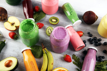 Fototapeta na wymiar Multicolored smoothies and juices from vegetables, greens, fruits and berries, food background. Detox and dieting, clean eating, healthy lifestyle concept