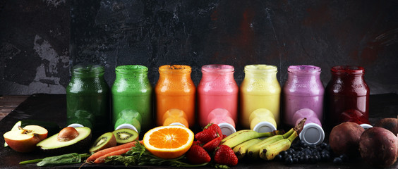 Multicolored smoothies and juices from vegetables, greens, fruits and berries, food background....