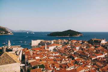View from the wall on the roofs of the old city of Dubrovnik, the bell tower of the Dominican monastery, the dome of the church of St. Vlah and the Cathedral of the Assumption of the Virgin Mary - obrazy, fototapety, plakaty