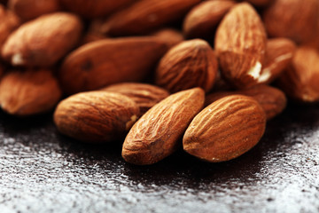 Almonds on a rustic background and almond in bowl.