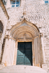 Statue above the entrance with a large stone staircase to the Dominican Monastery in Dubrovnik.