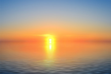 Naklejka na ściany i meble A bright sun before sunset reflected in the sea