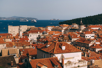 View from the wall on the roofs of the old city of Dubrovnik, the bell tower of the Dominican monastery, the dome of the church of St. Vlah and the Cathedral of the Assumption of the Virgin Mary - obrazy, fototapety, plakaty