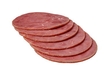 Sliced sausage slices lie on a white background. Isolated.