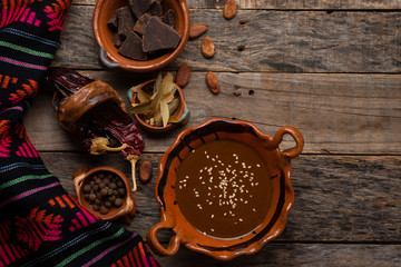 Mexican mole sauce on wooden background - obrazy, fototapety, plakaty