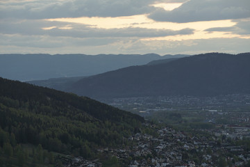 Fototapeta premium View at city cituated in a valley between mountains in evening time.