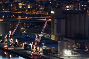 Two cranes lighten with pink color in night time. © oleksandr