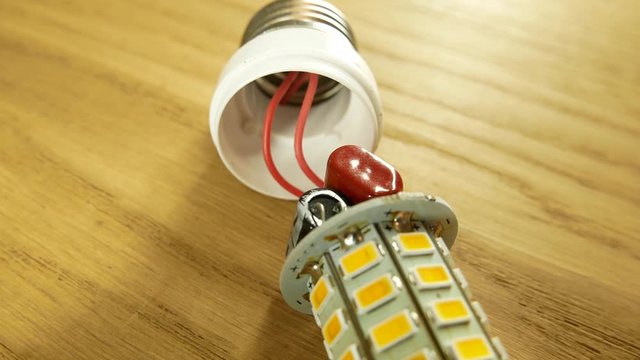 Socket E27 on the LED lamp. Capacitors and soldering board are visible.