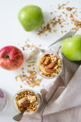 Apple parfait with yogurt and granola on a marble surface
