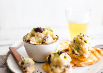 Cod fish brandade on a white ceramic and rustic napkin