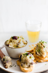 Cod fish brandade on a white ceramic and rustic napkin
