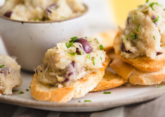 Cod fish brandade on a white ceramic and rustic napkin