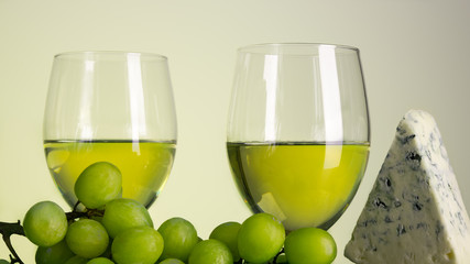 White wine. Still life with grapes and Blue cheese. Glass of alcohol drink. 