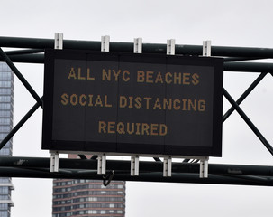 As the COVID-19 coronavirus pandemic grows, city officials place public messages and signs to advocate social distancing and to wear face masks to help prevent its spread