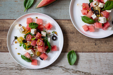 Summer salad with watermelon, tomatoes, feta cheese and basil