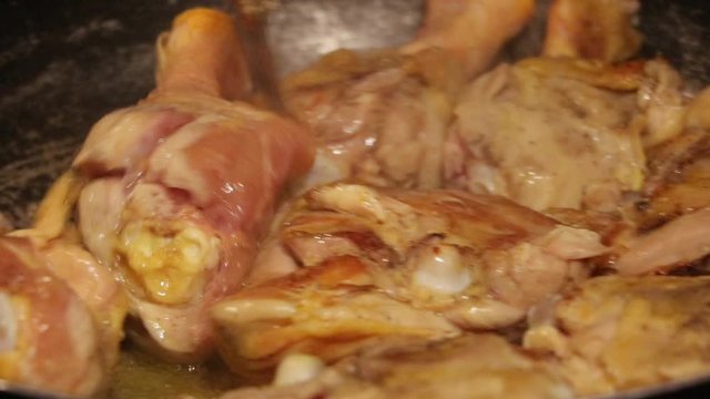 Golden chicken with olive oil in a frying pan