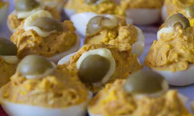 EGGS STUFFED WITH MAYONNAISE AND OLIVES IN CLOSE-UP