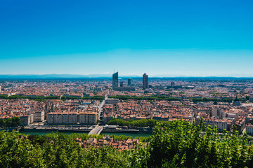 Fototapeta na wymiar Lyon panorama elevated view on sunny day. Aerial panoramic view of Lyon with the skyline. Top view of Lyon cityscape with Pont Marechal Juin and Rhone river from Fourviere Hill