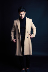 handsome asian fashion looking man posing in studio on black background, lifestyle modern people concept