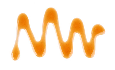 Caramel syrup drizzle isolated on white background. Splashes of sweet caramel sauce. Top view.