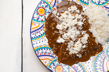 Mexican mole enchiladas with rice on white background