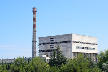 old Soviet factory with a pipe. Abandoned Soviet industry.