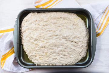 Rosemary focaccia dough on baking sheet