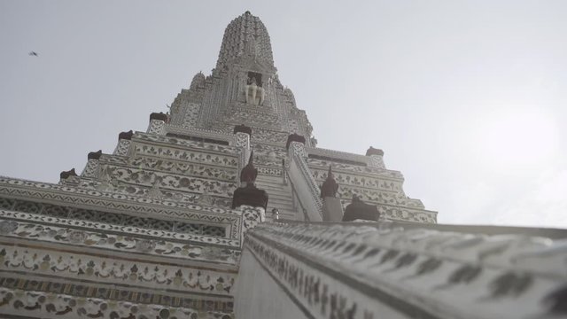 Low angle view of intricate design on Buddhist temple building in city against sky - Bangkok, Thailand