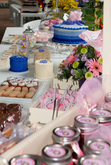 Table served in city hotel, birthday celebration, patisserie and themed decoration, interior with tables and tablecloth.