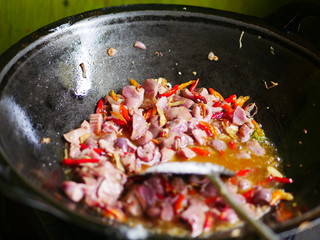 Preparing stir fry chicken offals with traditional herbal chilly sauce in Asia. Hot an spicy food menu. Oriental menu in Chinese restaurant.