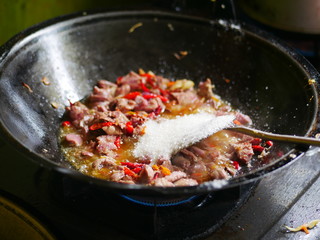 Preparing stir fry chicken offals with traditional herbal chilly sauce in Asia. Hot an spicy food menu. Oriental menu in Chinese restaurant.