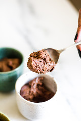 Chocolate mousse on tiny cups and marble background