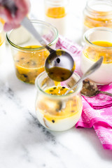 passion fruit panna cotta on tiny glasses and pink napkin