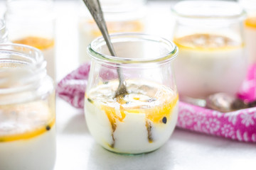 passion fruit panna cotta on tiny glasses and pink napkin