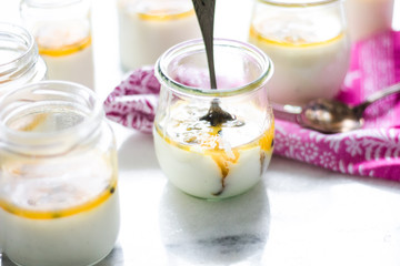passion fruit panna cotta on tiny glasses and pink napkin
