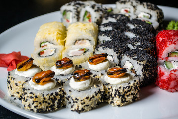 Set of rolls with mussels on a white plate closeup